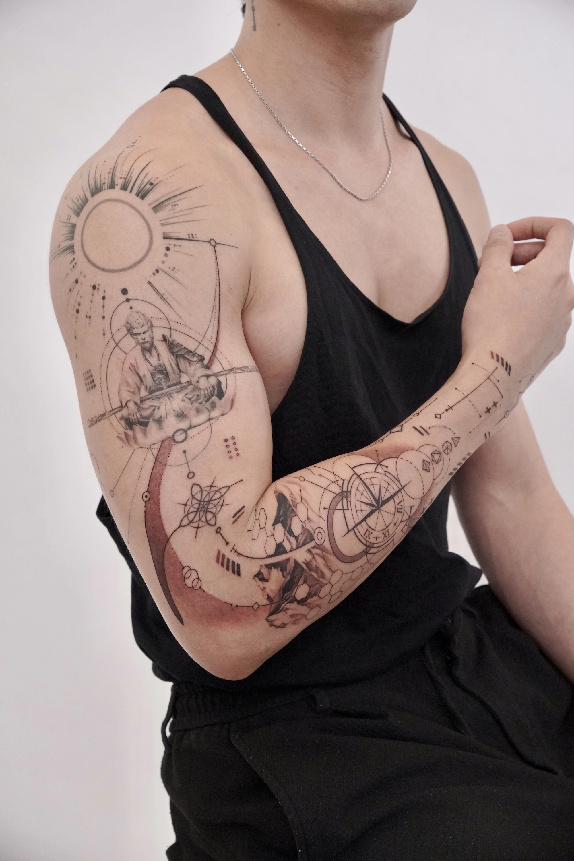 1747618702-graphic-style-tattoo-arm