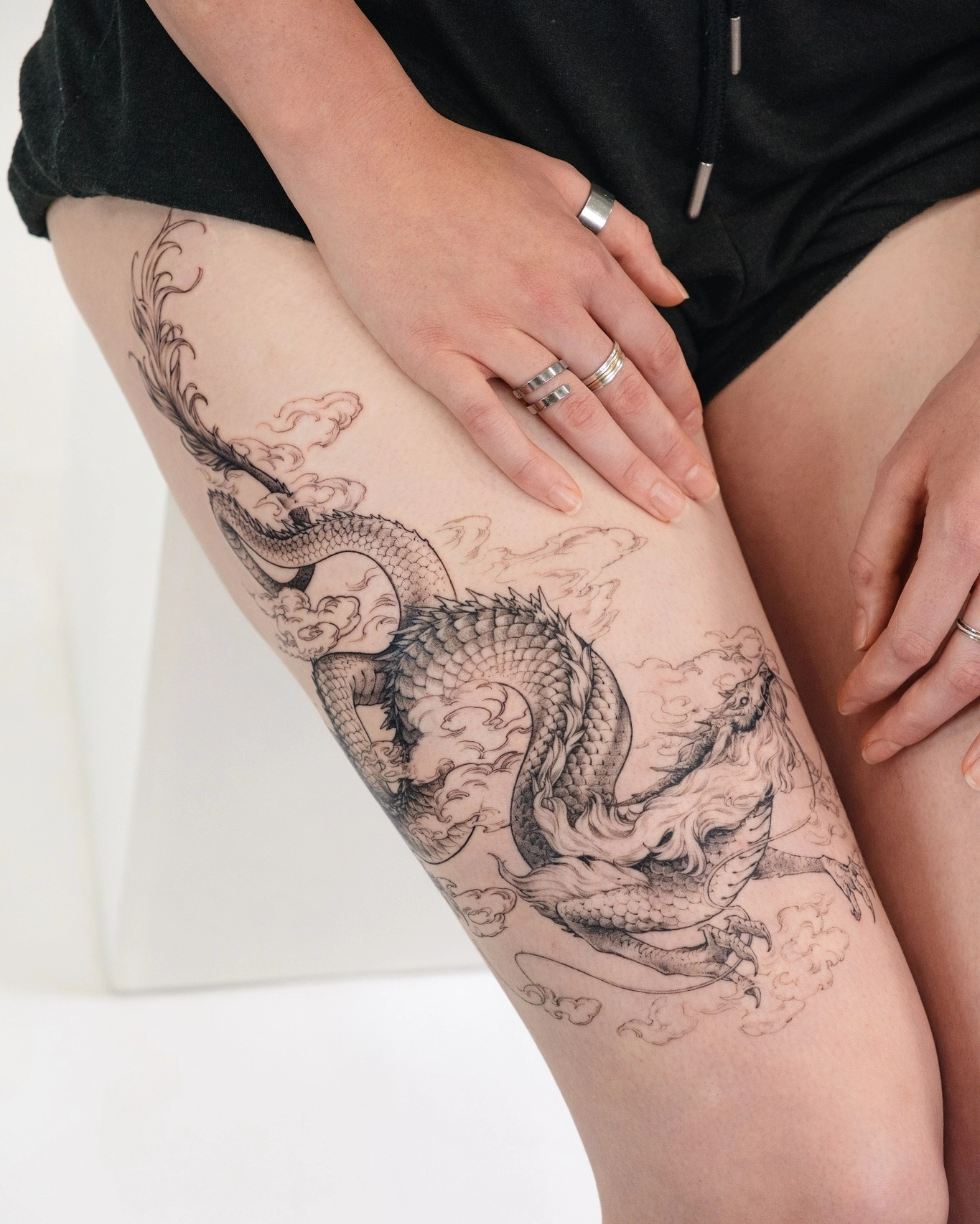 1747822949-dragon-tattoo-thigh-fineline