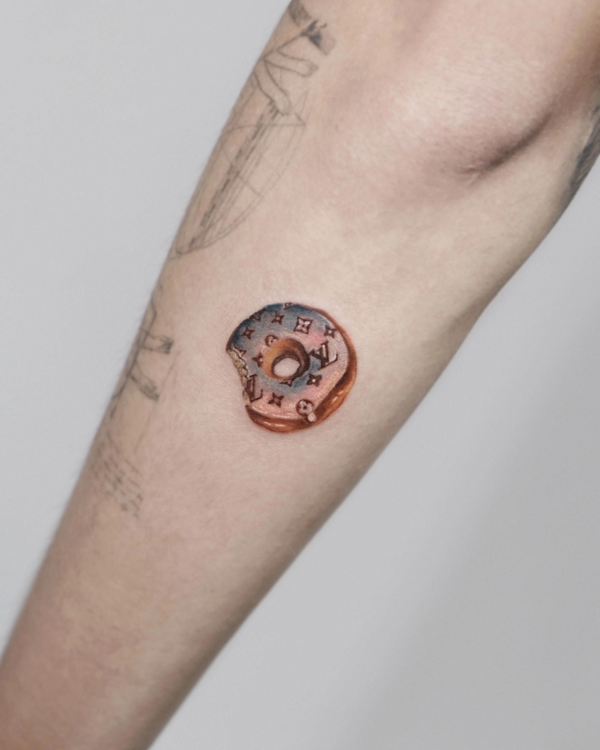 1748560528-lv-donut-small-color-tattoo-1